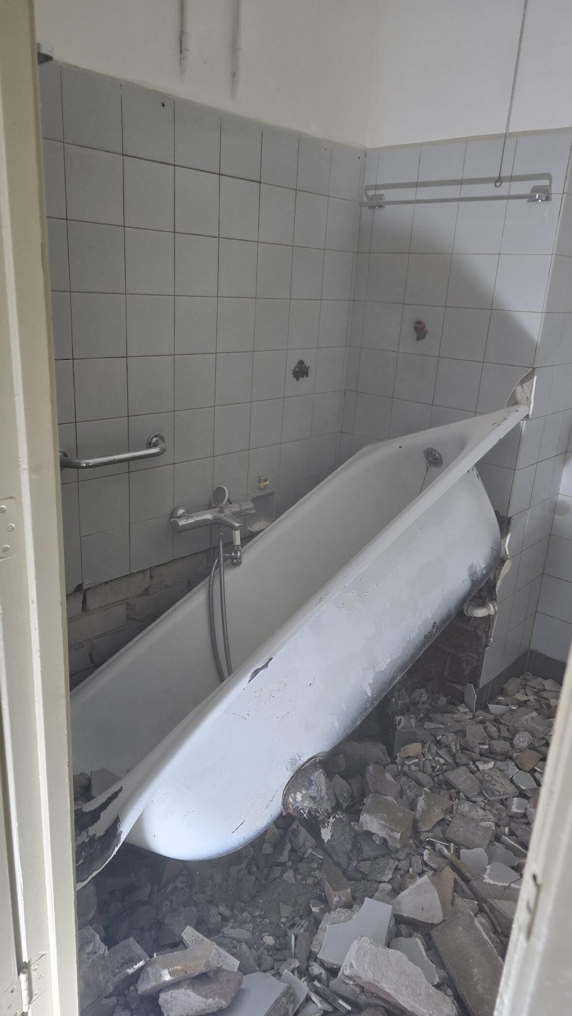 a bathtub in a bathroom ready for demolition