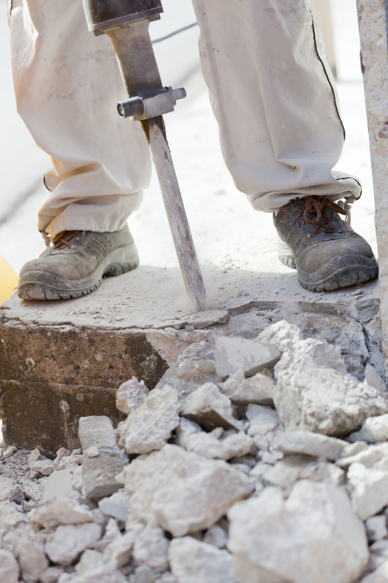 a person using a jackhammer to break rubble